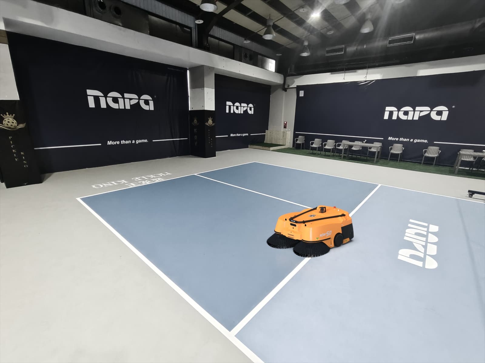 Commercial cleaning robot maintaining floor surfaces in a school gym or public facility